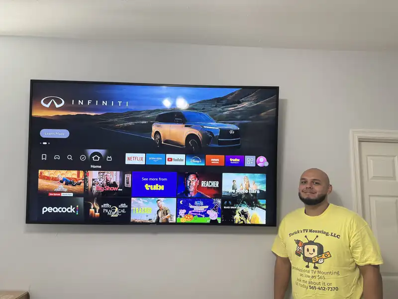 85-inch TV mounted on a finished living-room wall in Jupiter, FL, installed by Tarick's TV Mounting technician Noel