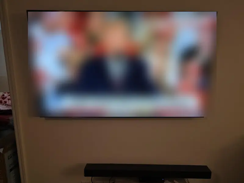 TV mounted on a full-motion mount above a connected soundbar in a Merritt Island, FL living room