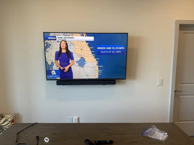 55-inch TV and soundbar mounted on a living-room wall in Royal Palm Beach, FL with no visible cables