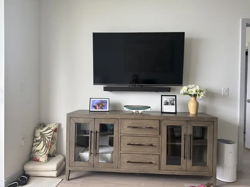 Customer photo of a wall-mounted TV and soundbar above a wooden console in Royal Palm Beach, FL